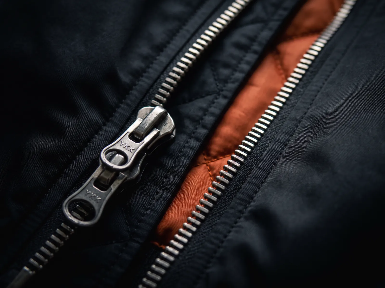 Close-up of a metal two-way zipper